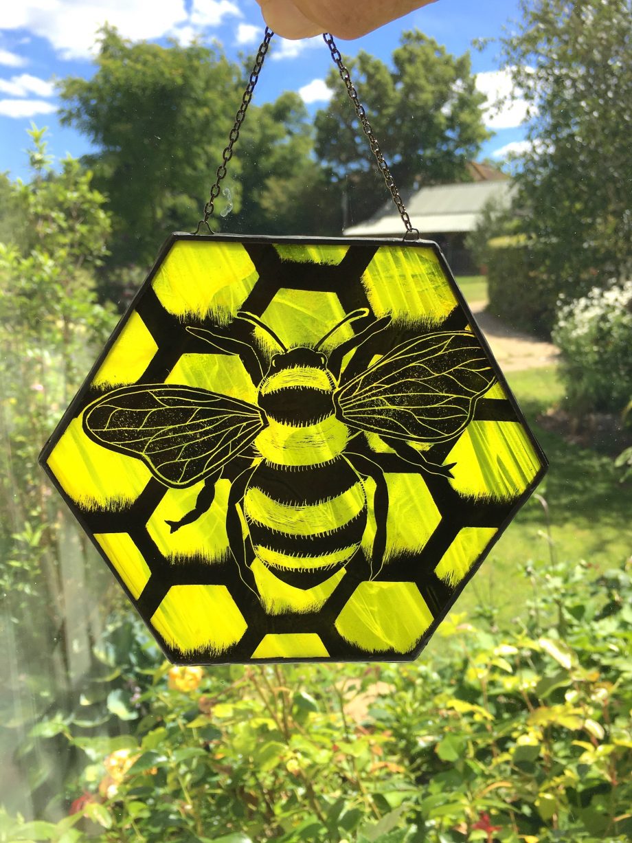 Stained glass honey bee sun catcher in window