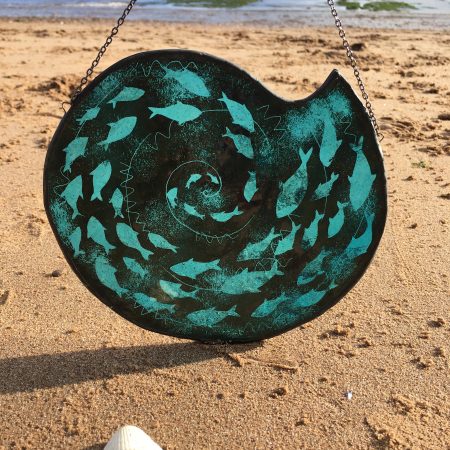 Stained glass fish spiral on beach