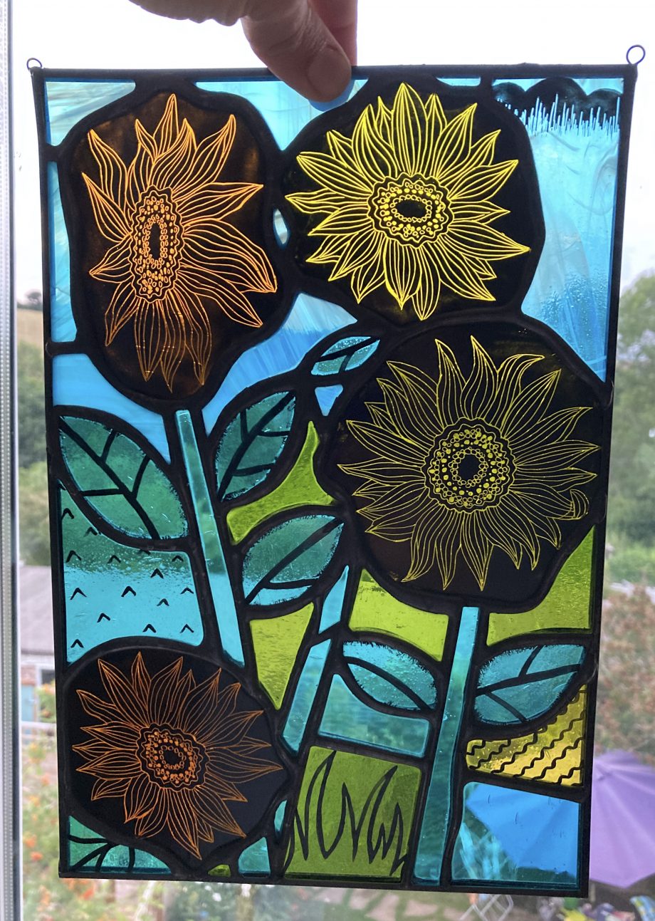 Stained glass sun catcher of yellow and orange sun flowers