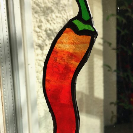 Stained glass red chilli on window