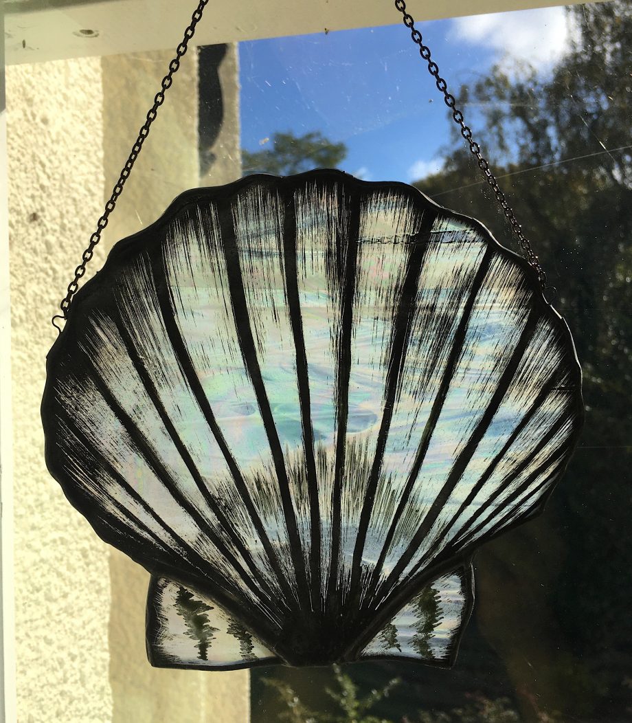 Stained glass scallop hanging on window