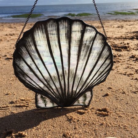 Stained glass scallop on beach