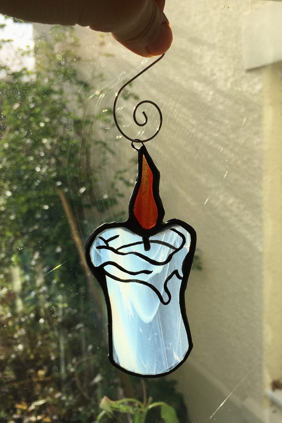 Stained glass xmas candle in window